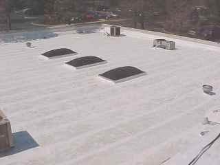 View of roof with equipment, skylite before final coating by Roof Menders