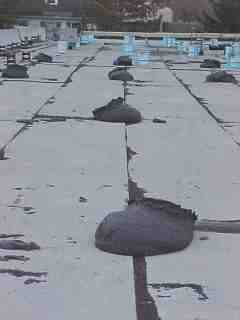 Foundation material is placed on roof in intervals by Roof Menders