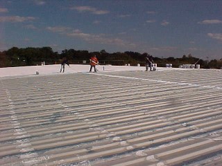 Cool white roof after flashing and as the first coat is applied by Roof Menders