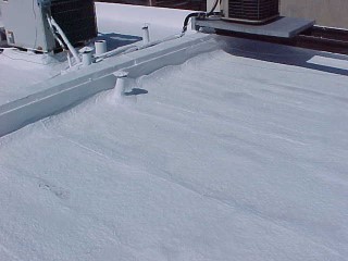 White acrylic roof coating over foam roof by Roof Menders